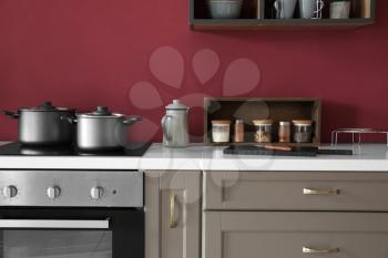 Cookware with spices on counter in modern kitchen�
