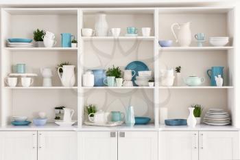 Open cupboard with clean dishes in kitchen�