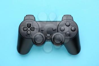 Modern game pad on color background�