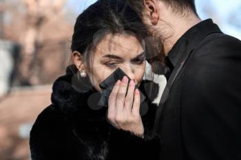 Couple pining after their relative at funeral�