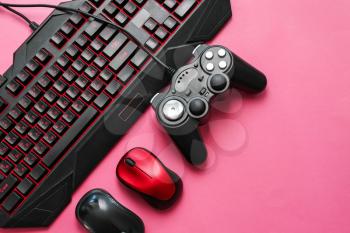 Modern gaming accessories on color background�