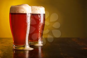 Glasses of fresh beer on table�