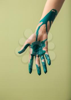 Painted hand on color background�