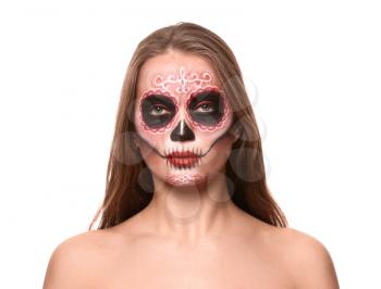 Young woman with painted skull on her face for Mexico's Day of the Dead against white background�