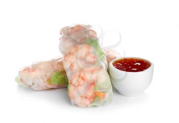 Tasty spring rolls with sauce on white background�