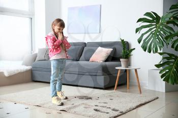 Little girl in muddy shoes messing up carpet at home�
