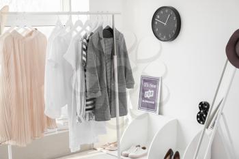 Interior of modern room with clothes rack�