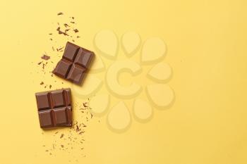 Sweet tasty chocolate on color background�