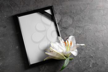 Blank funeral frame and flowers on grey background�