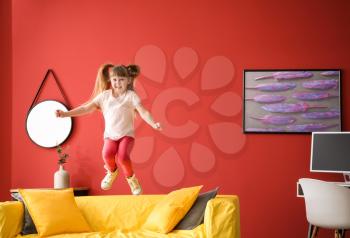 Jumping little girl at home�