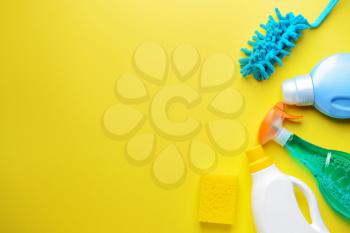 Set of cleaning supplies on color background�