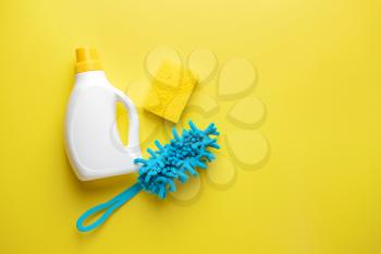 Set of cleaning supplies on color background�