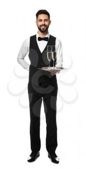 Handsome waiter with glasses of champagne on white background�
