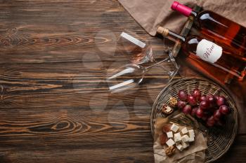 Composition with wine and snack on wooden background�