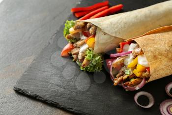 Tasty doner kebabs on slate plate�