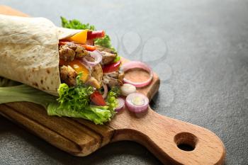 Tasty doner kebab on wooden board�