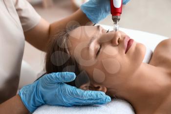 Young woman undergoing procedure of bb glow treatment in beauty salon�