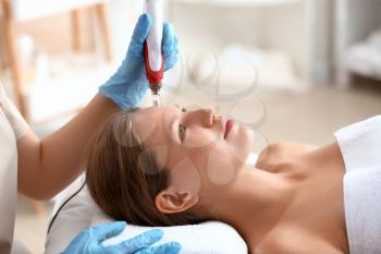 Young woman undergoing procedure of bb glow treatment in beauty salon�