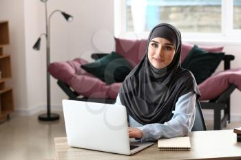 Young Muslim woman working in office�