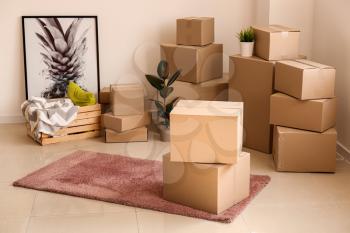 Moving boxes with belongings in empty room�