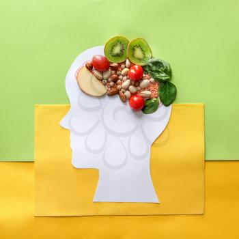Human head with different healthy products for brain on color background�