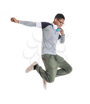 Portrait of jumping African-American teenage boy on white background�