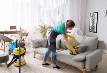 Female janitor cleaning room�