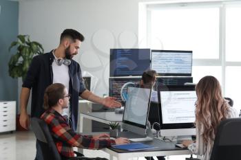 Team of programmers working in office�