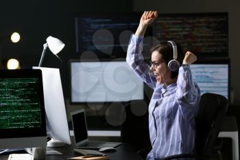 Happy female programmer working in office�