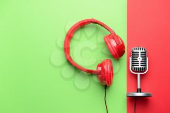 Retro microphone and headphones on color background�