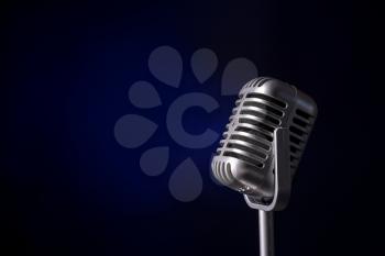 Retro microphone on dark color background�