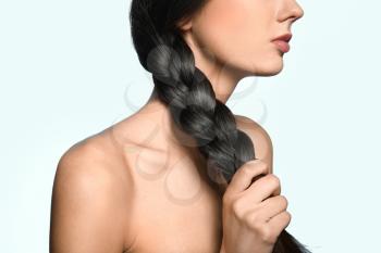 Beautiful young woman with healthy strong hair on color background�