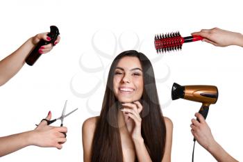 Beautiful young woman with healthy long hair and hairdresser's hands with tools on white background�