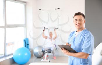 Young male physiotherapist in rehabilitation center�