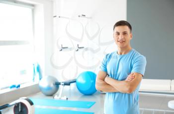 Young male physiotherapist in rehabilitation center�