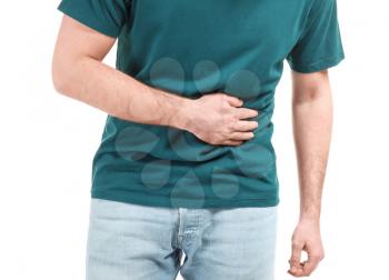 Young man suffering from stomachache on white background�