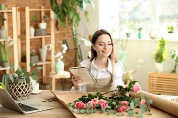 Young florist working in shop�