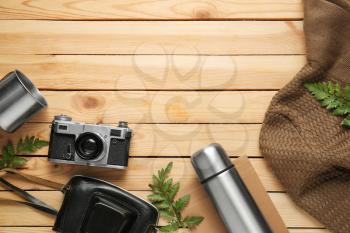 Set of items for tourist on wooden background�