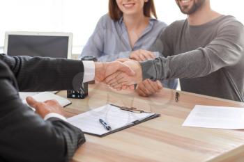 Man shaking hands with notary public in office�