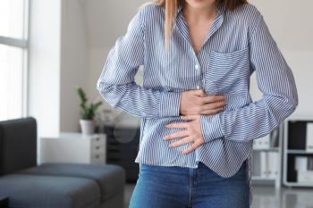 Woman suffering from stomachache at home�