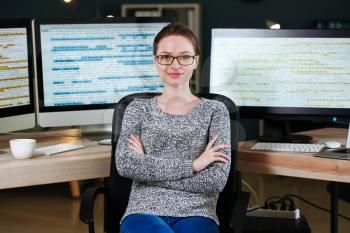 Portrait of female programmer in office at night�