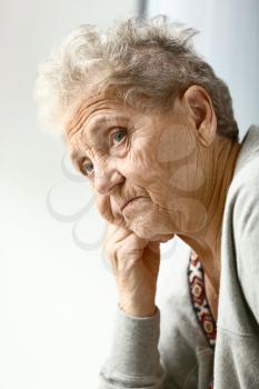 Portrait of depressed senior woman at home�
