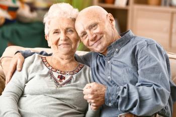 Portrait of happy senior couple at home�