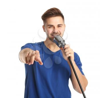 Handsome male singer with microphone on white background�