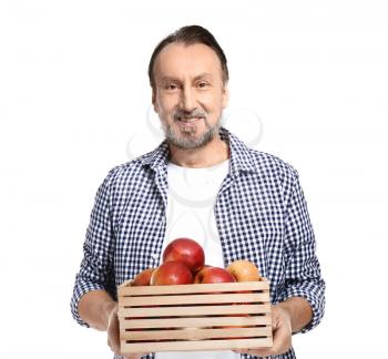Portrait of handsome mature farmer with apples in box on white background�