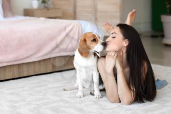 Young woman with cute dog at home�