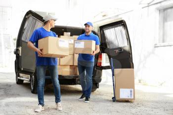 Delivery men carrying boxes to client�