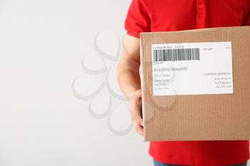 Delivery man with box on white background, closeup�