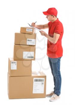 Delivery man with boxes and clipboard on white background�