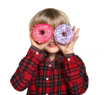 Happy little boy with tasty donuts on white background�